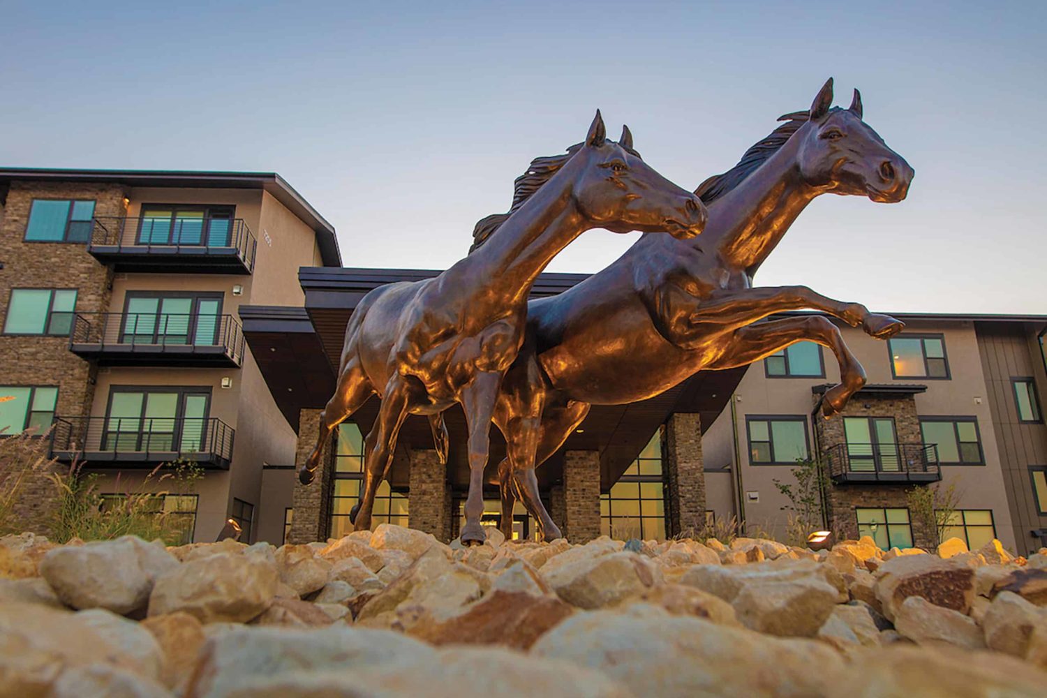 Windswept is a larger-than-life bronze horse sculpture featuring two wild, running horses. They sit at the entrance of The Ridge Pinehurst in Denver, Colorado.